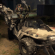 Three spartan soldiers drive a warthog in Halo Infinite's big team battle mode.